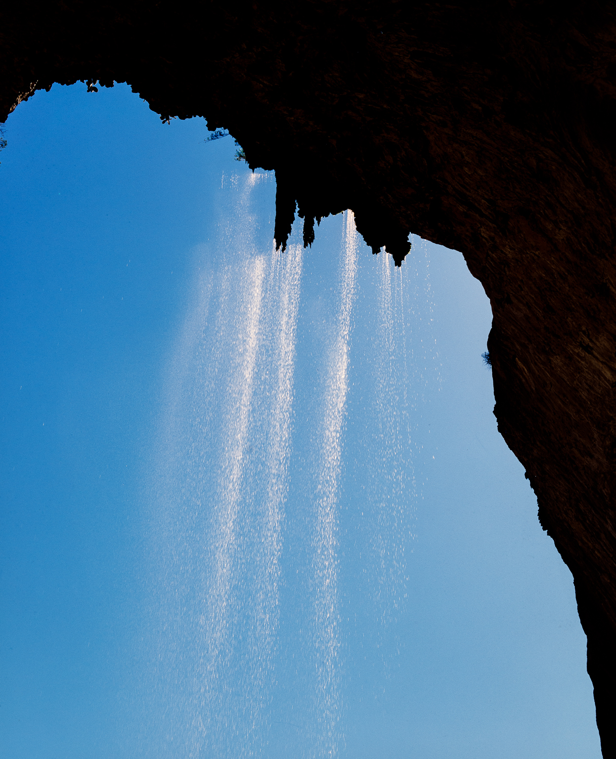 Morning Tonto Natural Bridge waterfall from under the bridge in mid-afternoon.